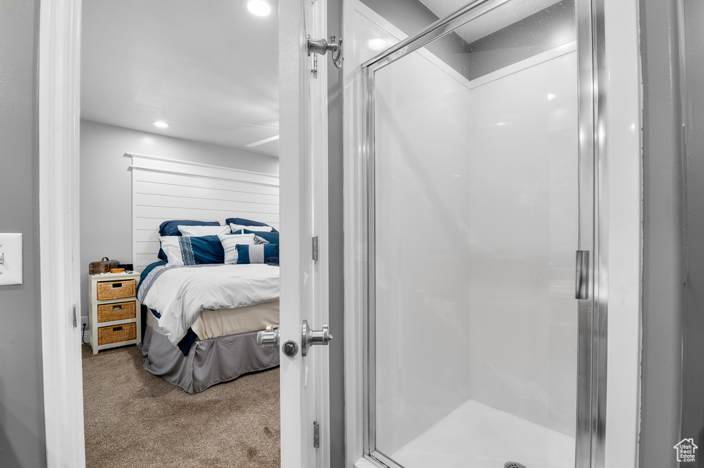 Ensuite bathroom featuring a shower stall and recessed lighting