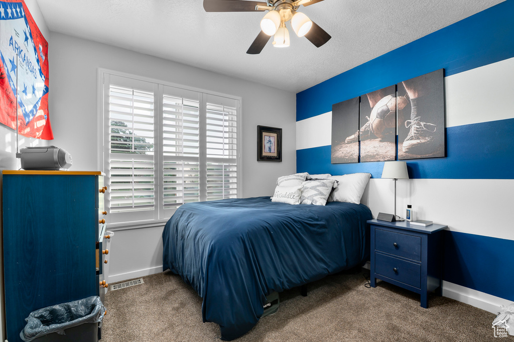 Bedroom with carpet floors and a ceiling fan
