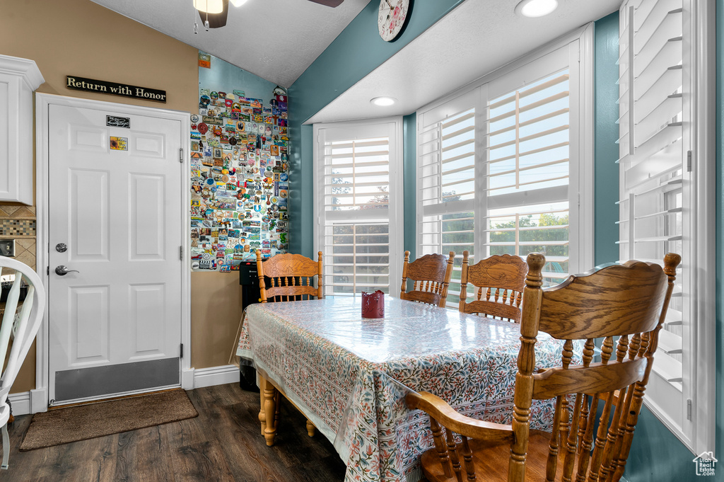 Dining area featuring vaulted ceiling, dark wood-style flooring, ceiling fan, and recessed lighting