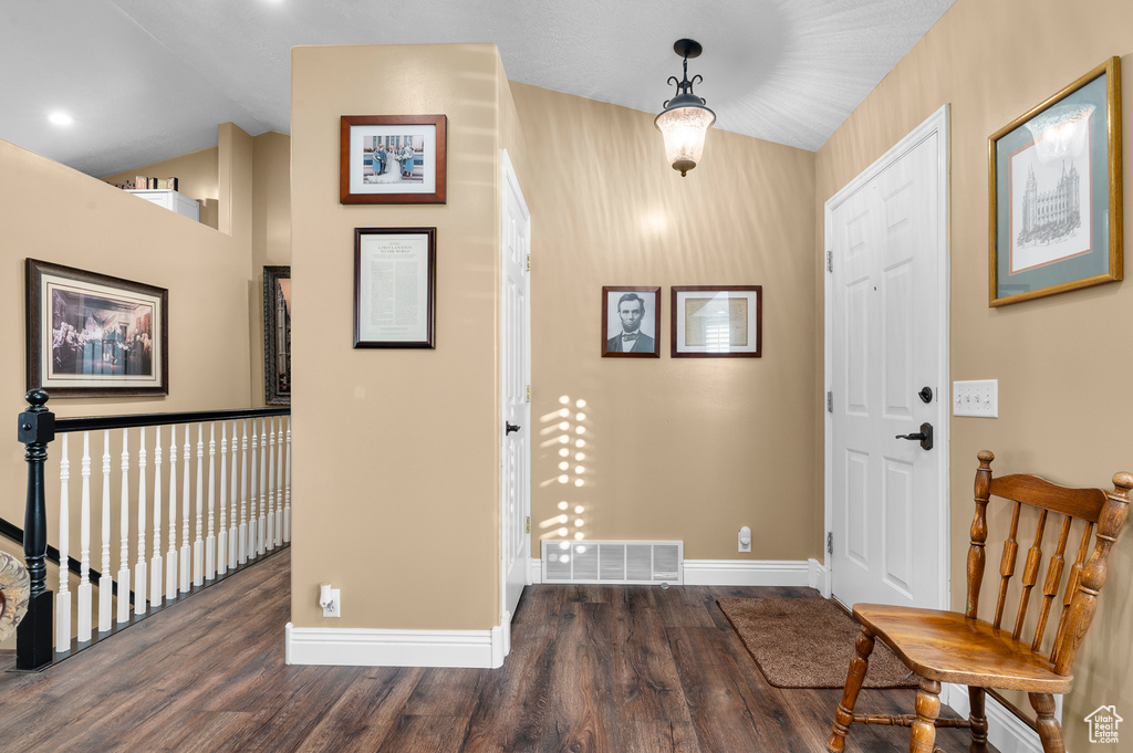 Entryway featuring wood finished floors and vaulted ceiling