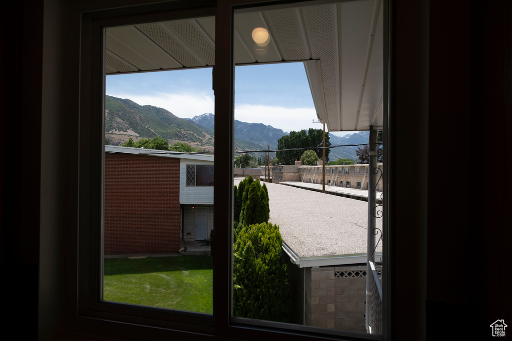 Doorway to outside featuring a mountain view and healthy amount of natural light