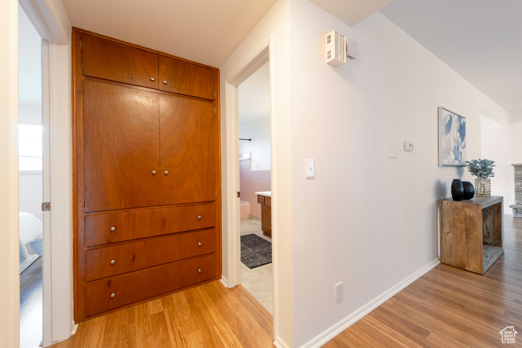 Hall featuring light wood-style floors and baseboards