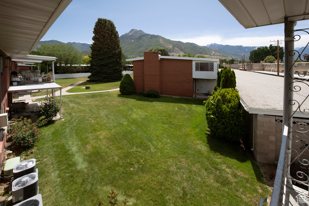 View of grassy yard featuring a mountain view