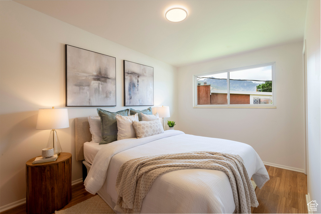 Bedroom featuring wood finished floors and baseboards