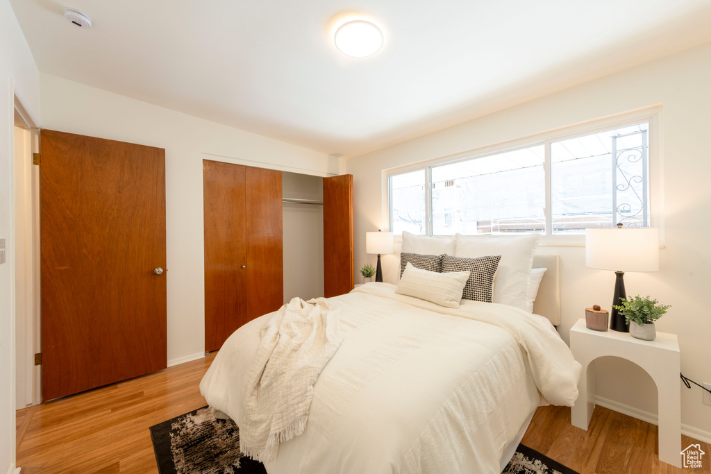 Bedroom featuring light wood-style floors and a closet