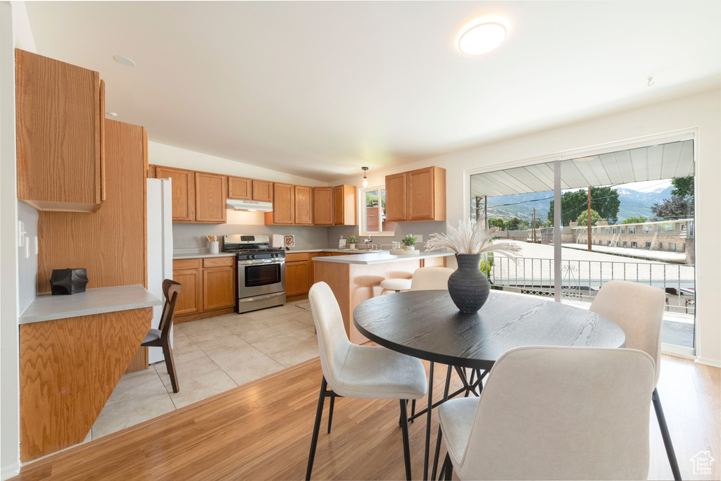 Dining space with lofted ceiling and light tile patterned floors