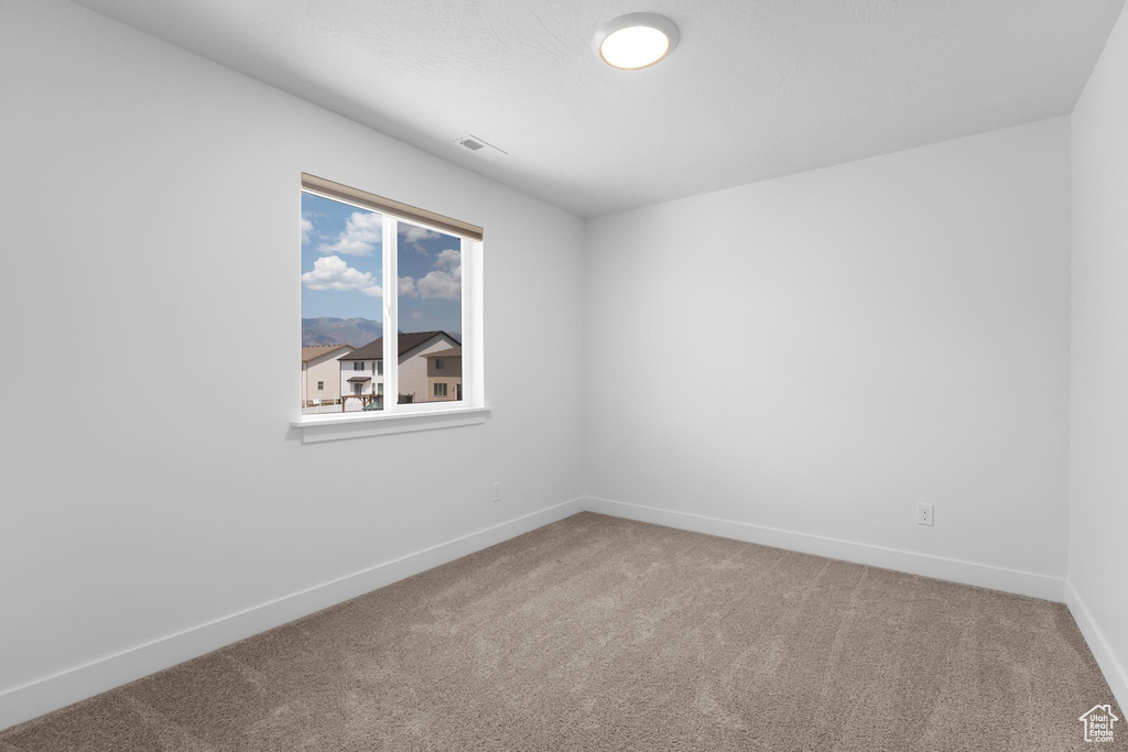 Unfurnished room featuring carpet flooring and baseboards