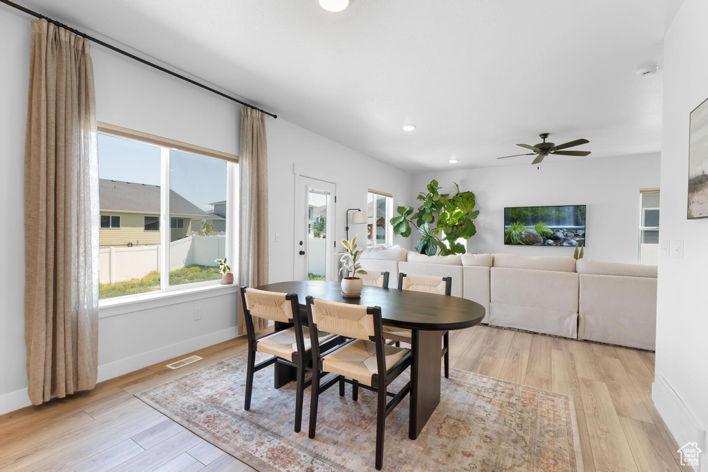 Dining space featuring light wood-style floors, plenty of natural light, ceiling fan, and recessed lighting