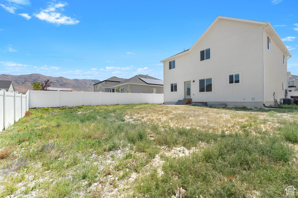 Back of property featuring a mountain view and stucco siding