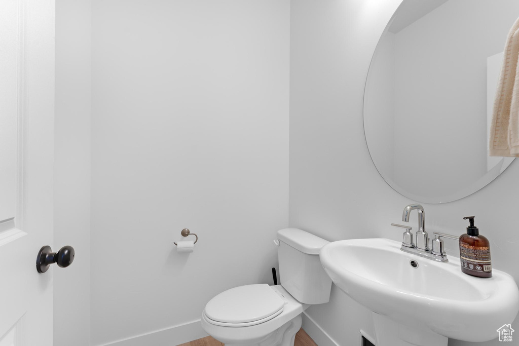 Bathroom featuring a sink and wood finished floors