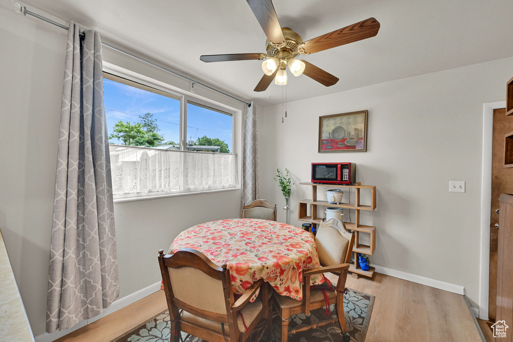 Dining area featuring wood finished floors and a ceiling fan