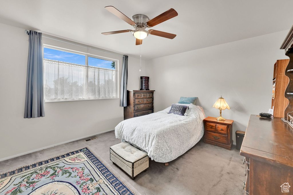 Bedroom featuring light carpet and ceiling fan