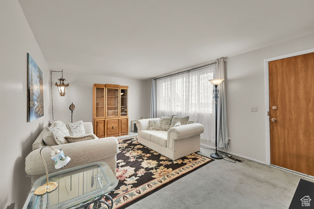 Carpeted living room featuring baseboards