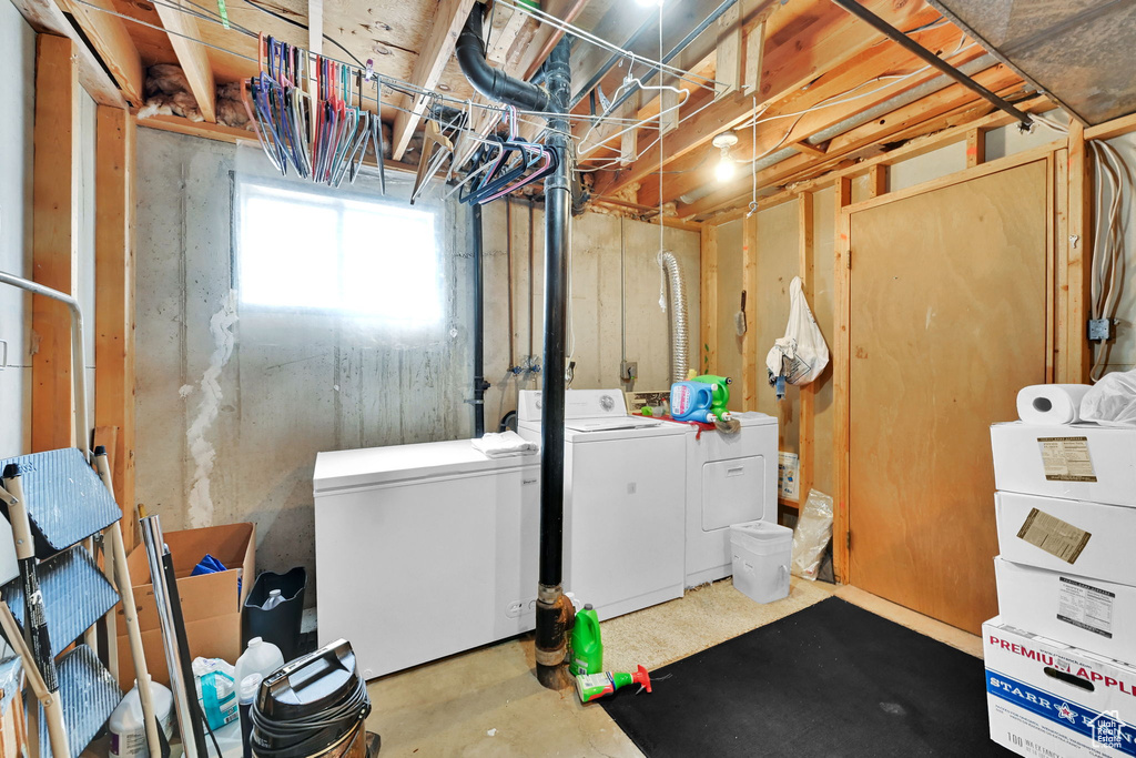 Below grade area with washer and dryer and refrigerator