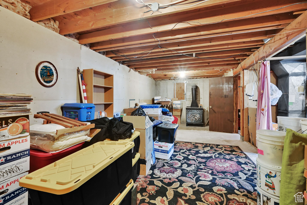 Unfinished below grade area featuring a wood stove