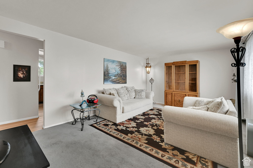 Living room with carpet flooring and baseboards