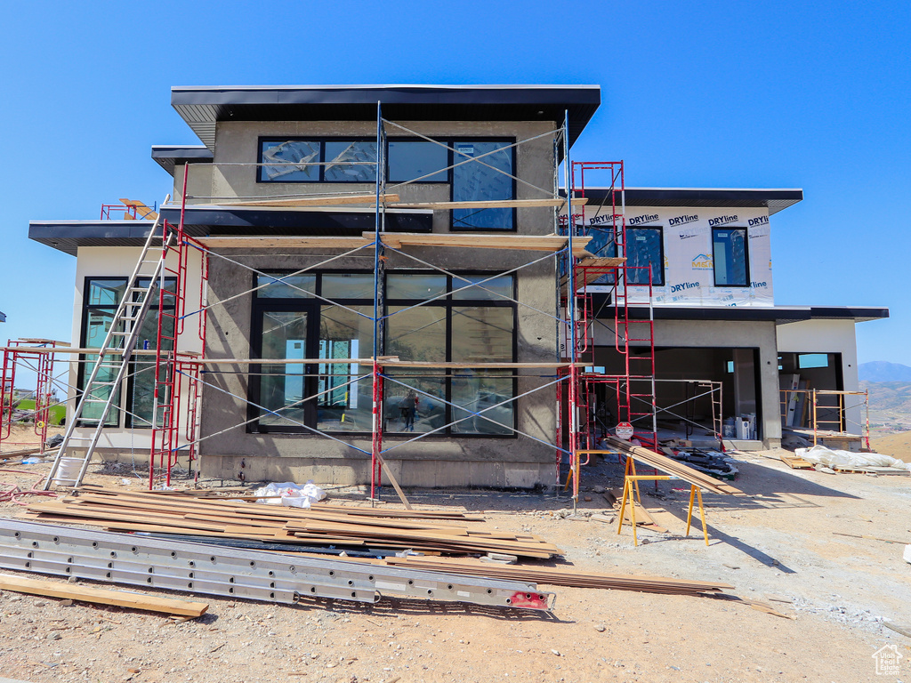 View of front facade featuring stucco siding