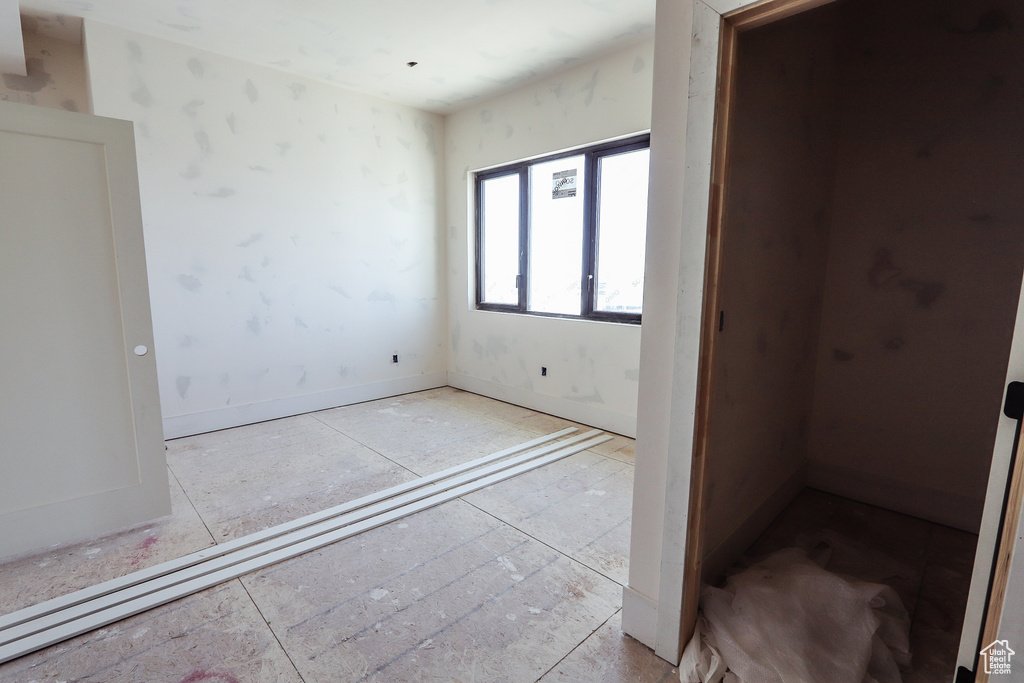 Unfurnished bedroom with baseboards