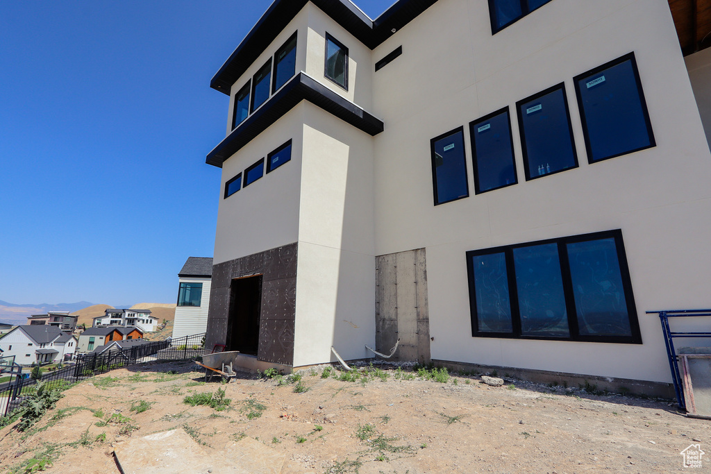 Back of property with stucco siding and a residential view