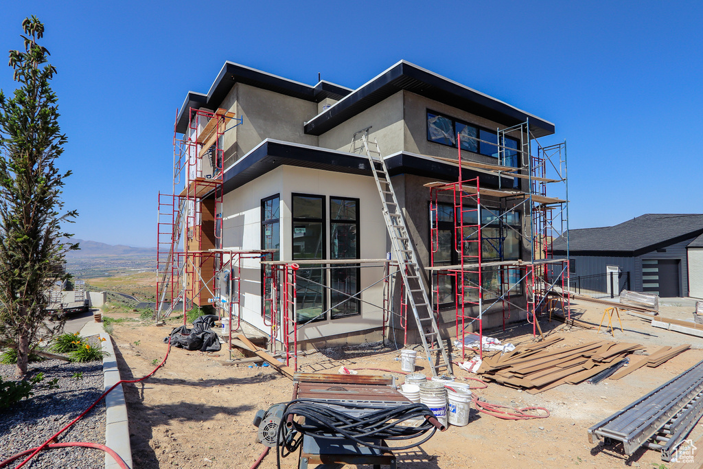 Rear view of property with stucco siding