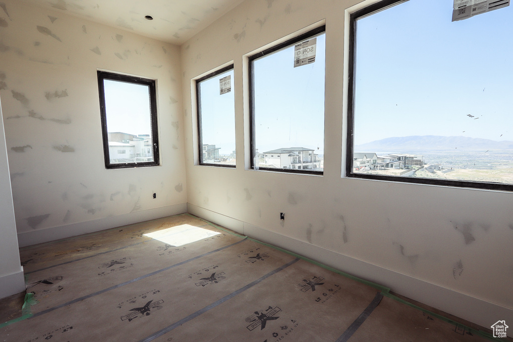 Spare room featuring baseboards and a mountain view