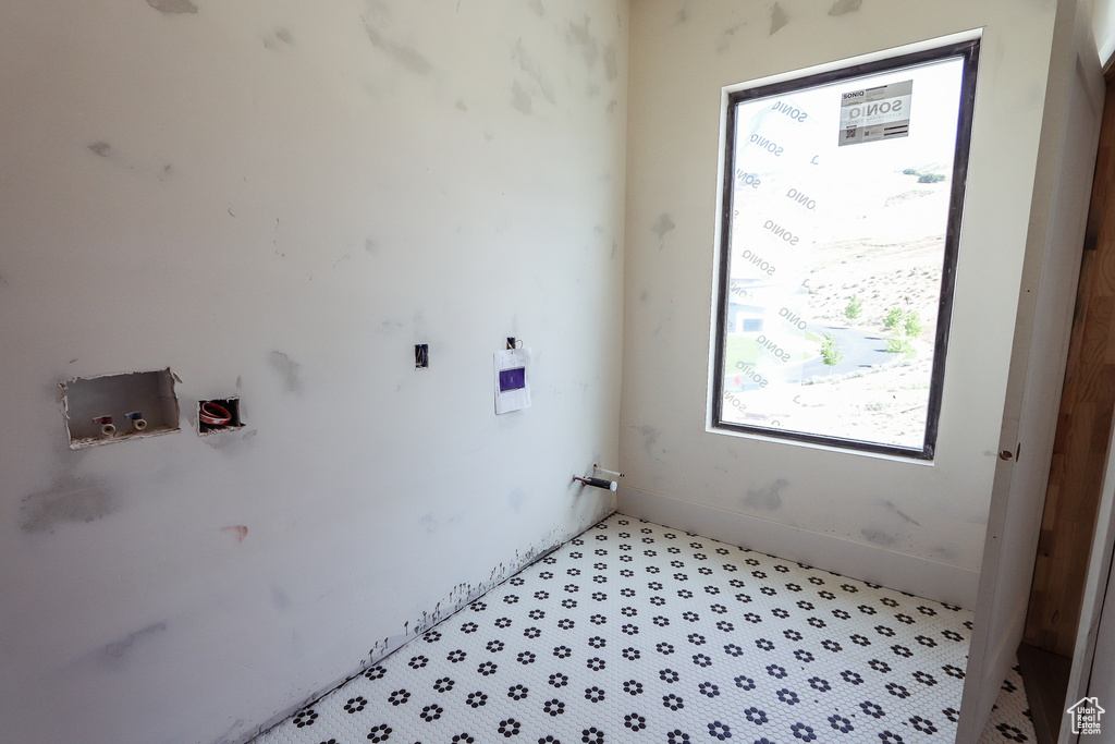 Laundry room featuring hookup for a washing machine and baseboards