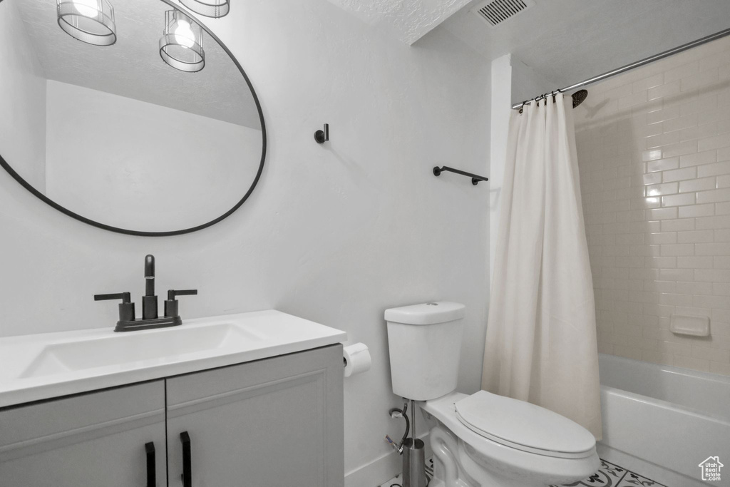 Full bathroom with vanity and shower / bath combo with shower curtain