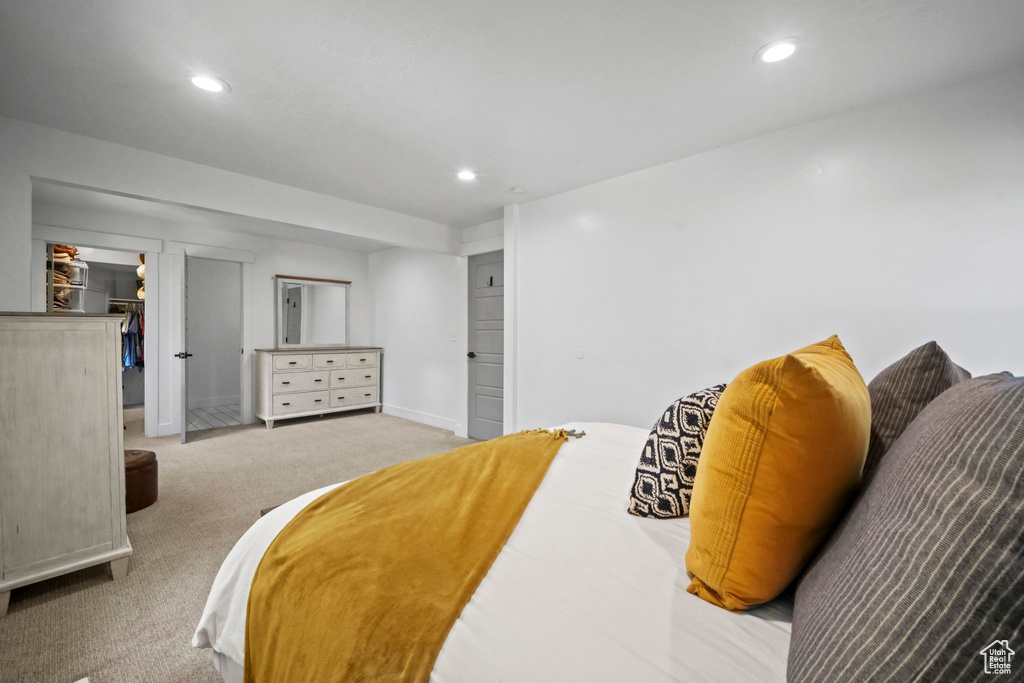 Carpeted bedroom with recessed lighting, a closet, and a walk in closet