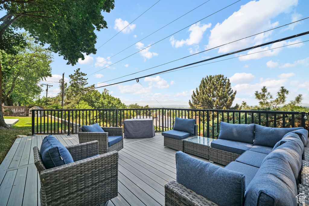 Wooden deck featuring an outdoor living space
