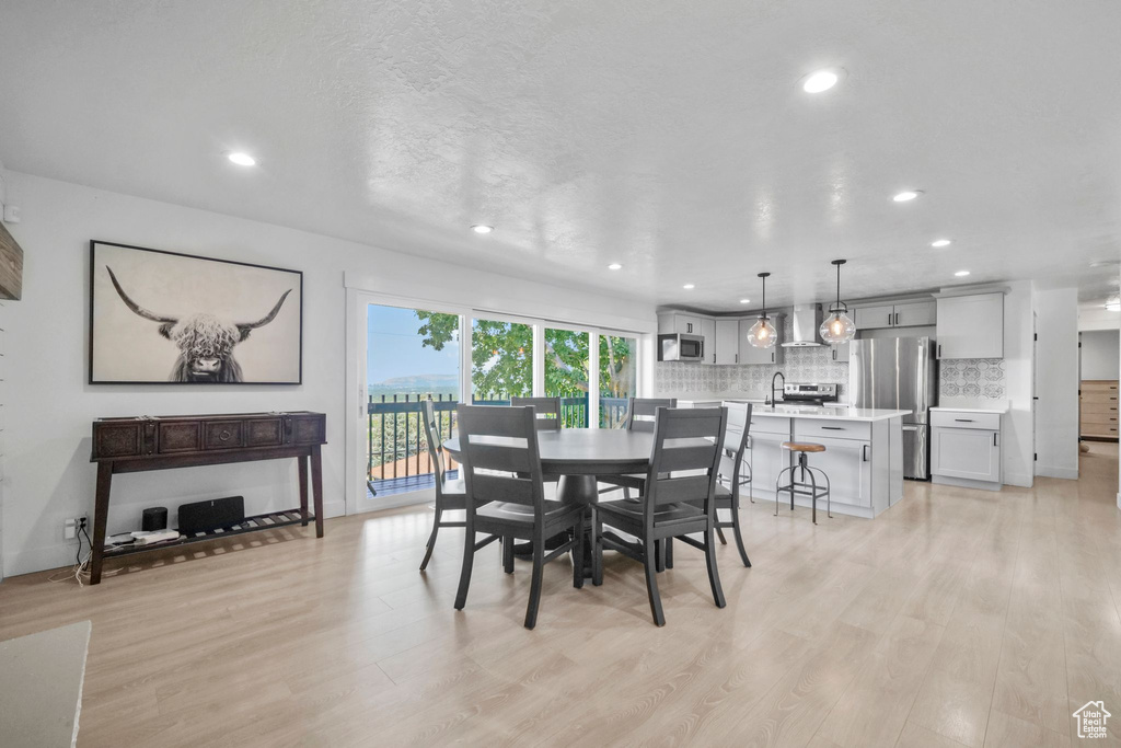 Dining room featuring light wood-type flooring and recessed lighting