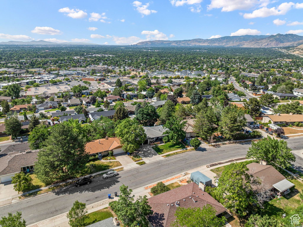 Aerial view of property's location with mountains and nearby suburban area
