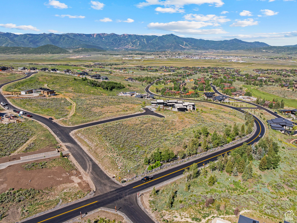 Aerial view of property's location featuring a mountainous background