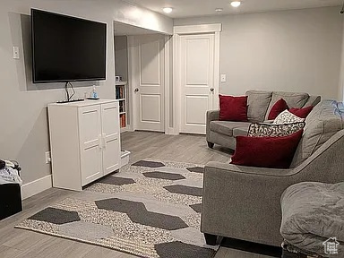 Living room with recessed lighting and light wood-type flooring