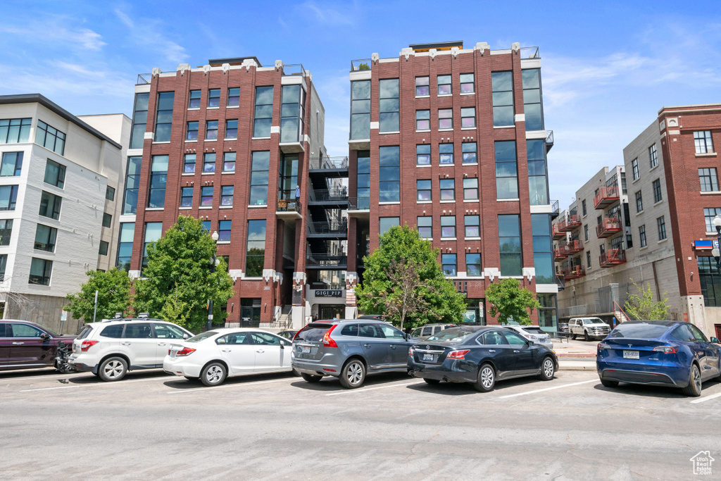 View of building exterior with uncovered parking