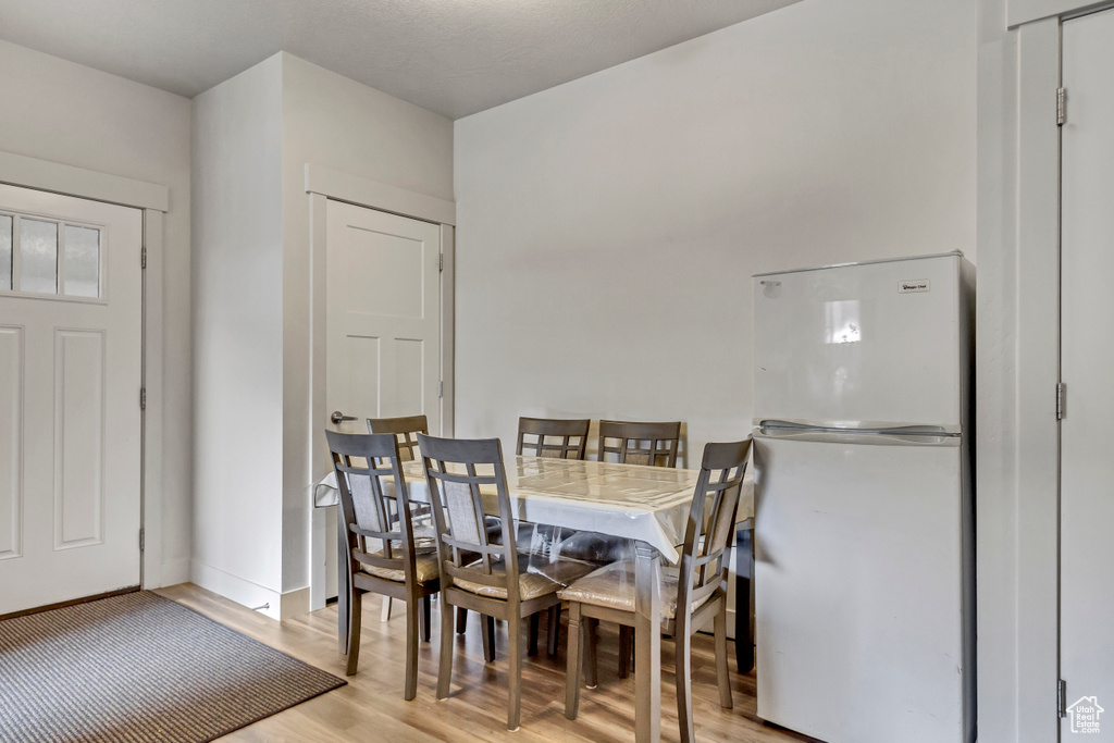 Dining room with light wood finished floors and baseboards