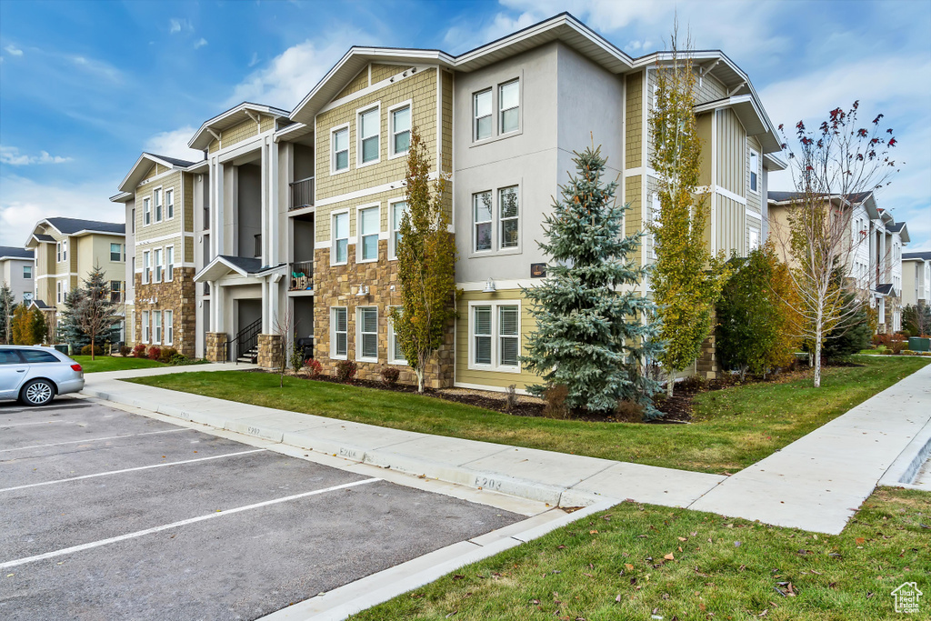 View of property featuring uncovered parking and a residential view