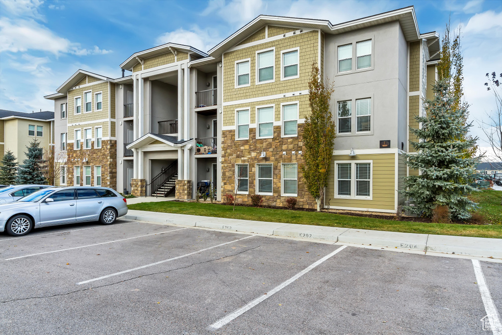 View of property featuring uncovered parking