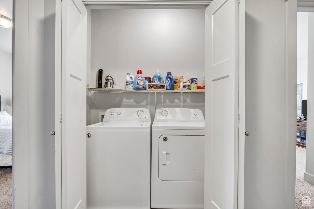 Laundry area with separate washer and dryer and carpet floors