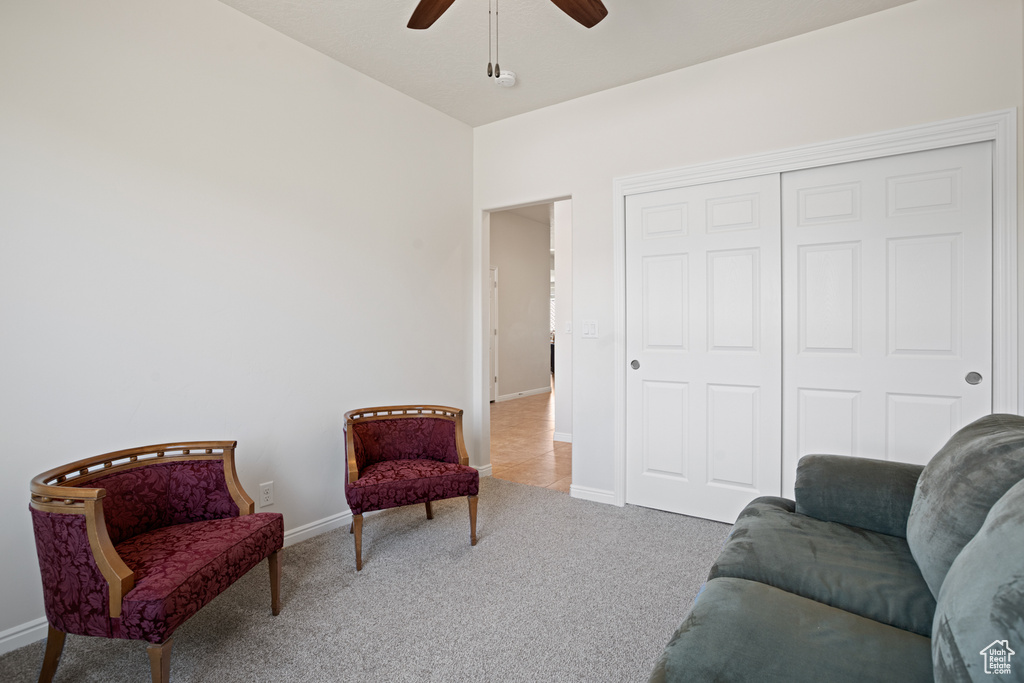 Sitting room with ceiling fan and carpet floors