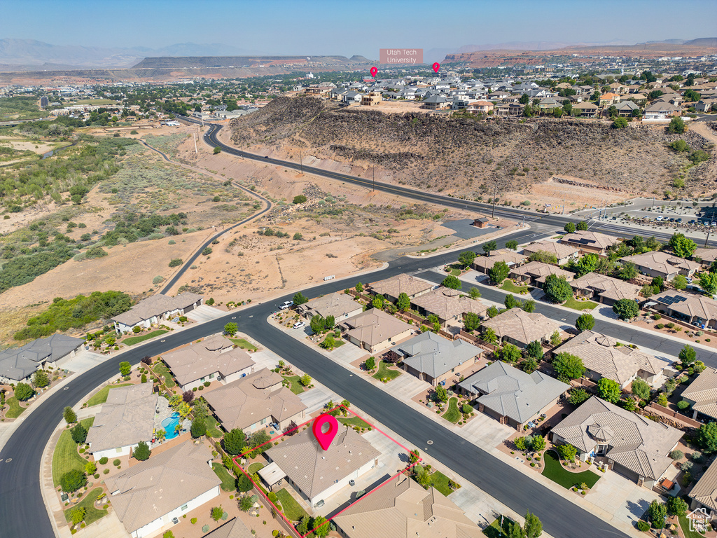 Aerial view of property's location with a mountain backdrop and nearby suburban area