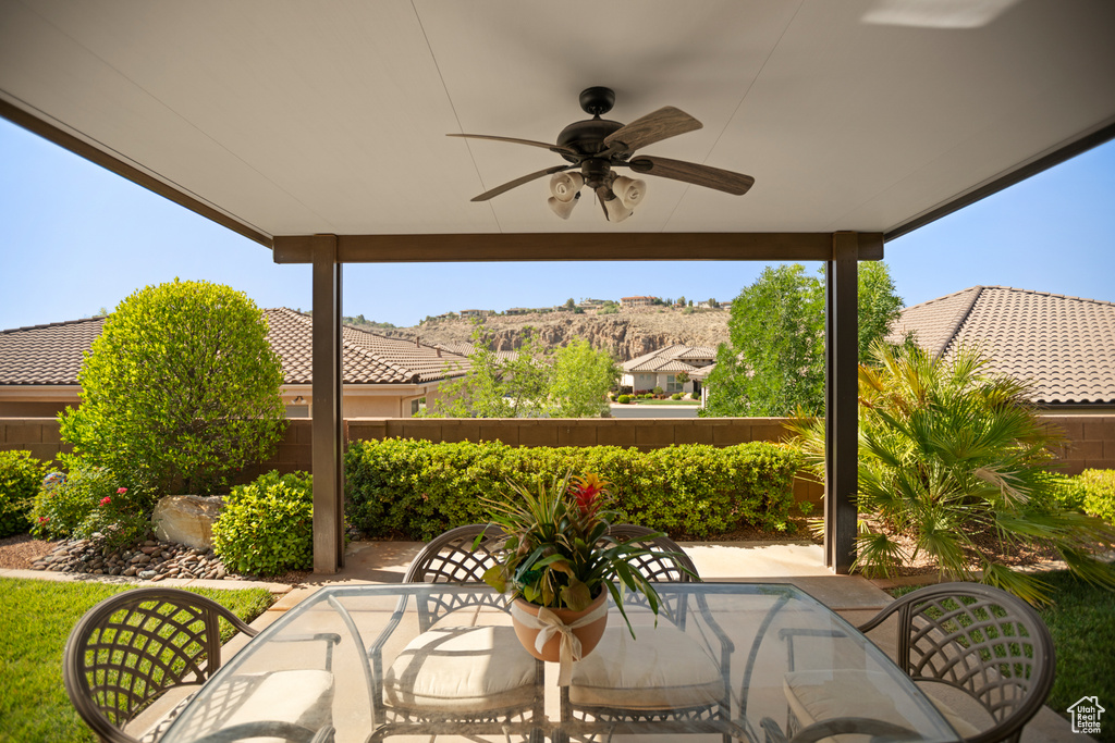 Fenced backyard featuring a ceiling fan, a patio, and outdoor dining area