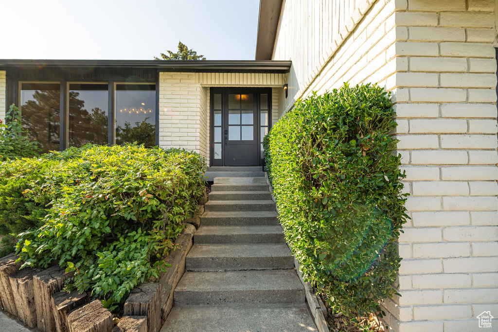 View of exterior entry featuring brick siding