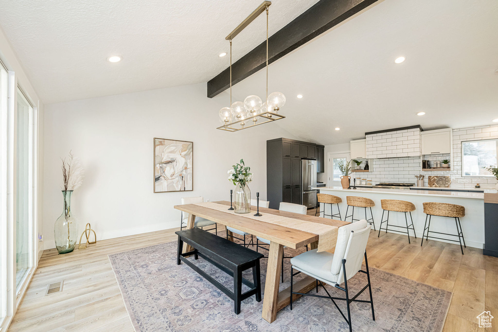 Dining space with light wood-style flooring, a chandelier, and recessed lighting
