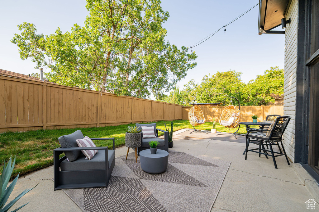 Fenced backyard featuring a patio area and an outdoor living space