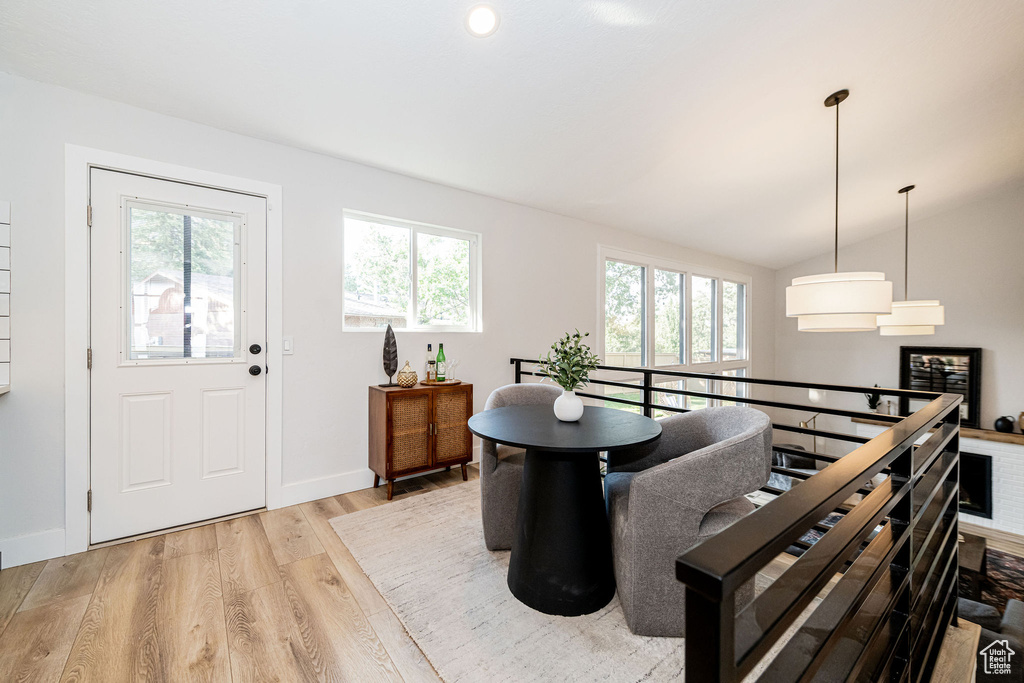 Dining space with wood finished floors and vaulted ceiling