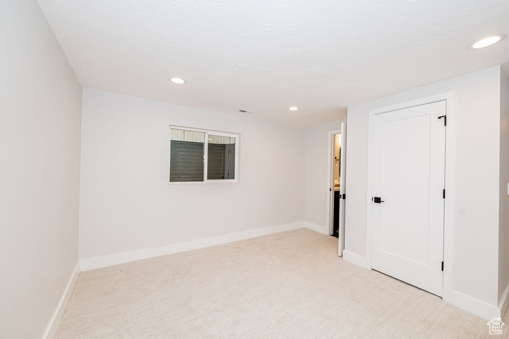 Unfurnished bedroom featuring recessed lighting and light colored carpet