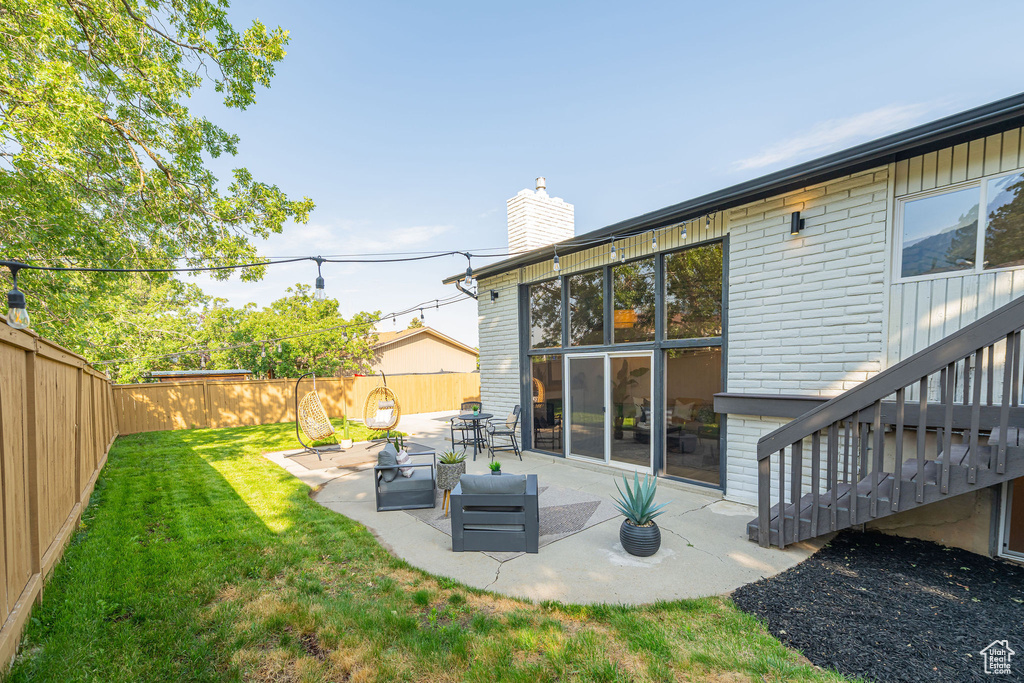 Fenced backyard with a patio
