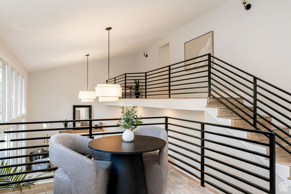 Stairway featuring wood finished floors and lofted ceiling