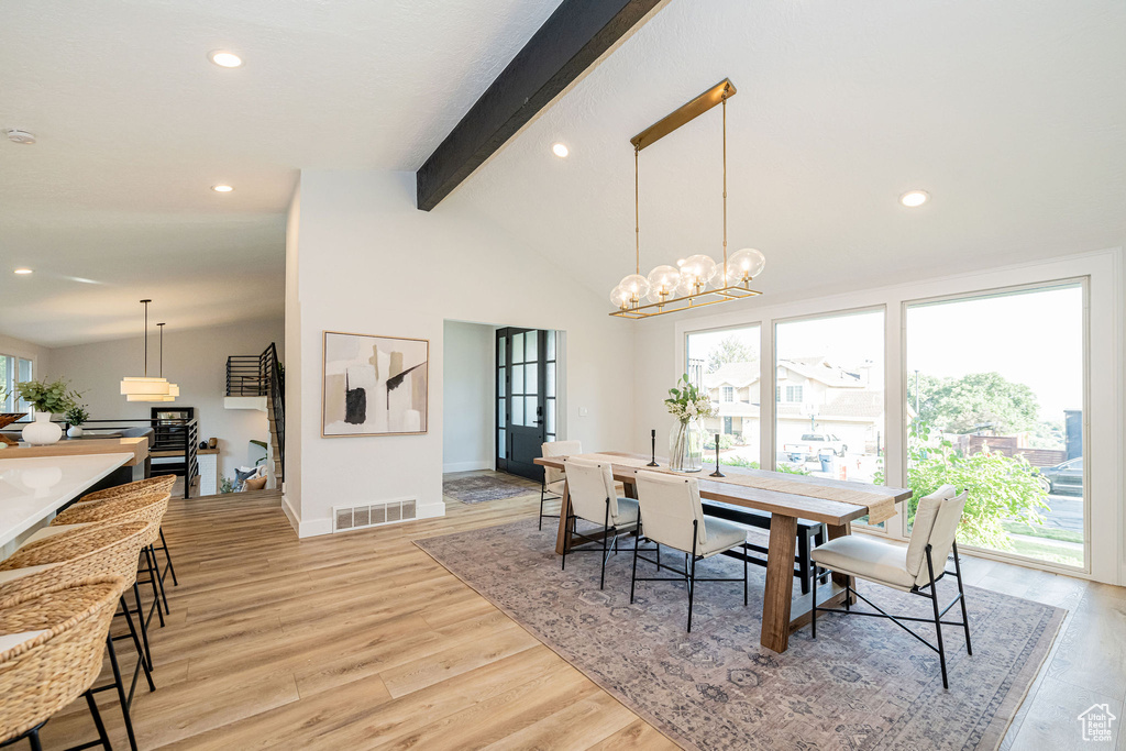 Dining area with recessed lighting, light wood-style floors, and a chandelier