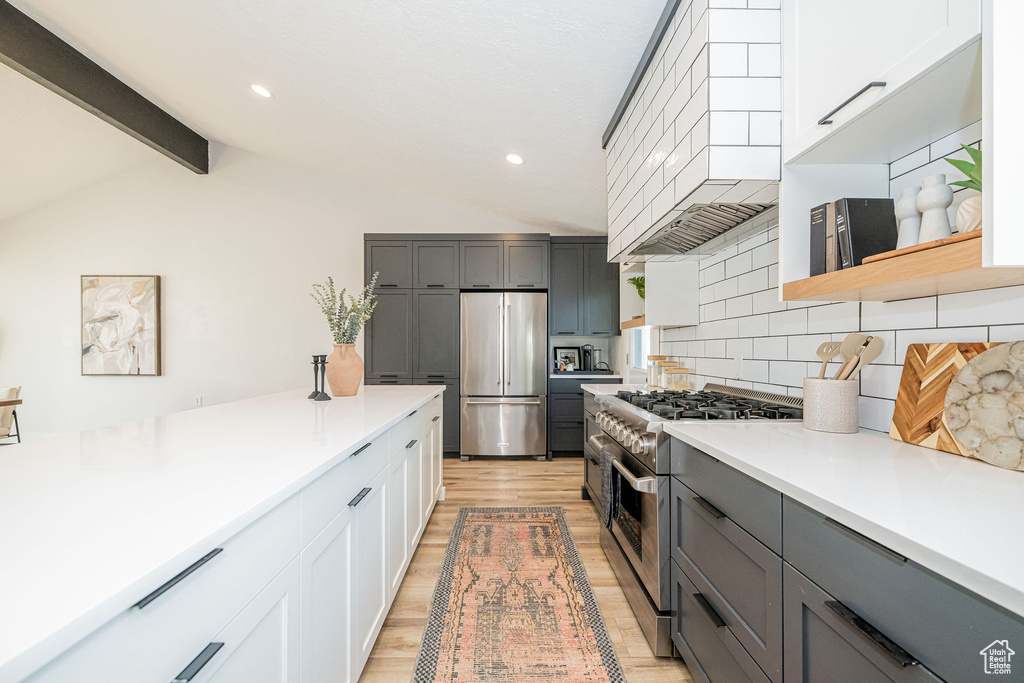 Kitchen featuring stainless steel appliances, custom exhaust hood, decorative backsplash, gray cabinets, and recessed lighting